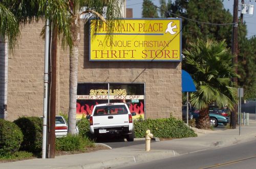 Sign: A Unique Christian Thrift Store; Window: Sizzling Summer Sale (with flames!)