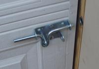 Close-up of a standard garage door lock.