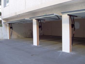 Image of open garage doors, lightened to showing more clearly that there's no separation behind them.