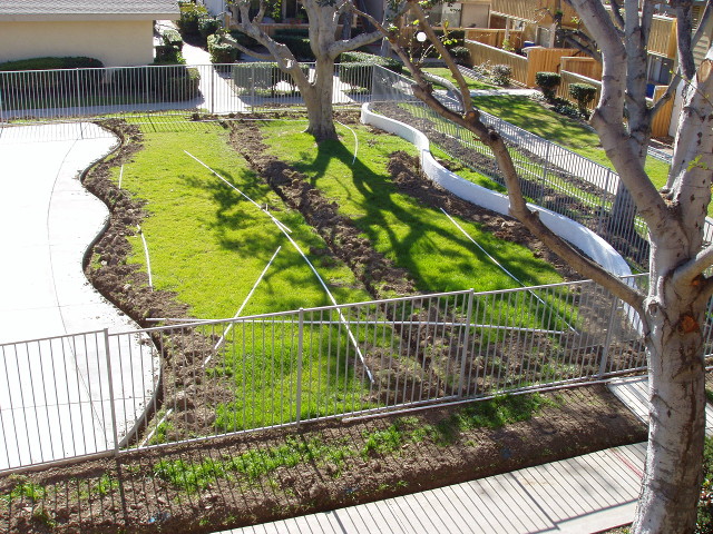 Picture of a courtyard dug up for new sprinklers
