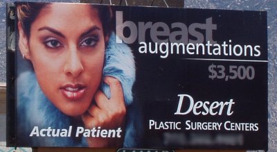 Billboard offering breast enhancement surgery with a picture of an 'actual patient' - but it's a head shot.