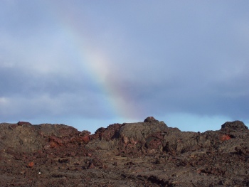 Rainbow over cooled lava