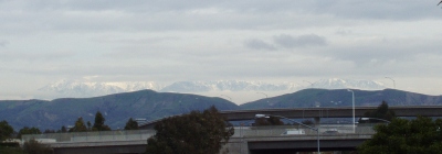 Two cloud layers, with mountains visible between them.