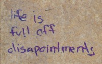 Writing on a tile: 'life is full of disapointments' [sic]