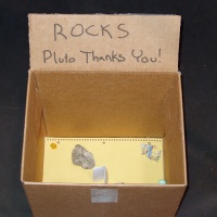 Cardboard box with rocks: Pluto thanks you!