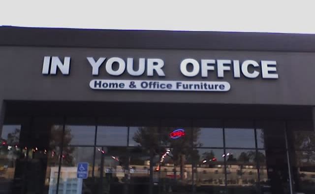 Storefront with a sign saying In Your Office: Home and Office Furniture