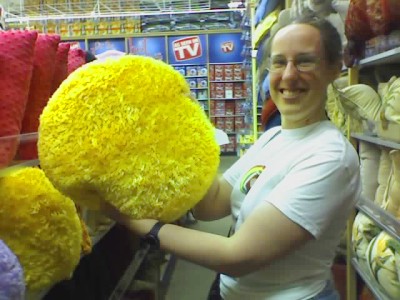 Picture of Katie holding up a fuzzy yellow pillow.
