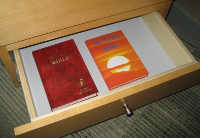 Hotel bedside drawer: Gideon Bible and The Teaching of Buddha