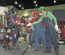 Optimus Prime shakes hands with Mario and Luigi