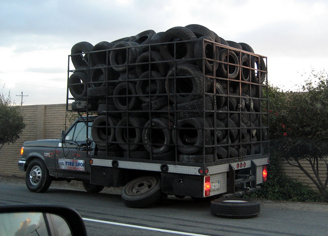 Truck full of tiresâ€¦ changing its tire!