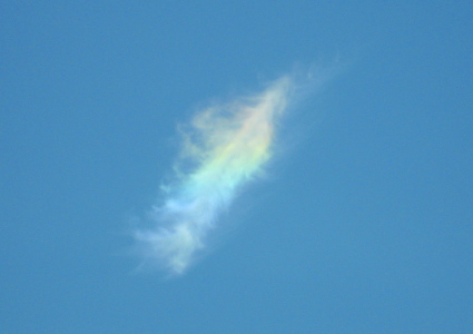 Feathery cloud banded from red to violet.