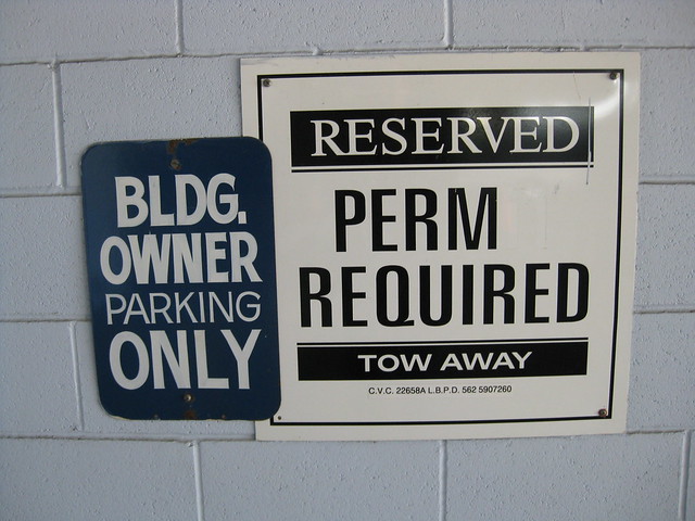 Sign in a parking lot: Reserved. Perm Required.