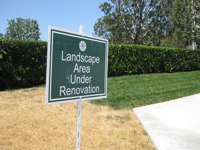 A sign saying 'Landscape under renovation,' planted in dead grass.