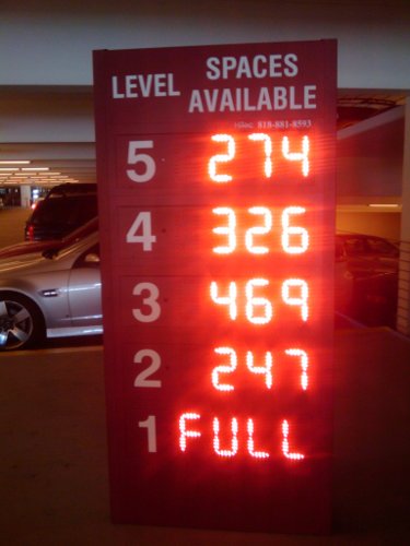 Parking structure sign showing 264 open spaces on level 5, 326 on level 4, 469 on level 3, 247 on level 2, and level 1 full.