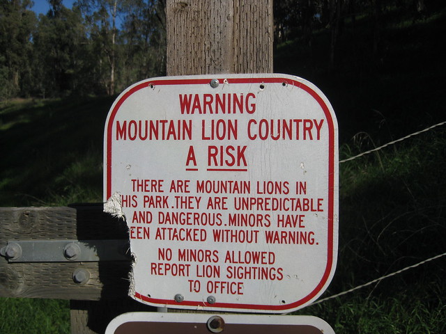 Damaged sign: Warning - Mountain Lion Country