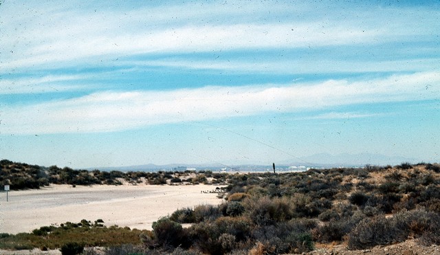 Hills and chaparral with the shuttle in the distance.