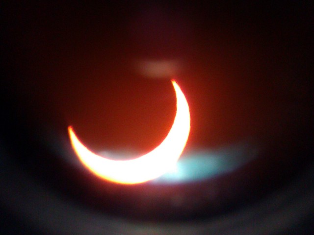 Solar eclipse seen through telescope eyepiece