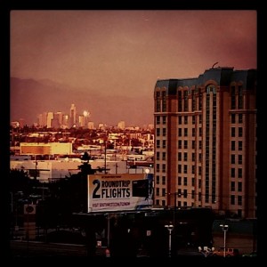 Los Angeles skyline in light, foreground in shadow.