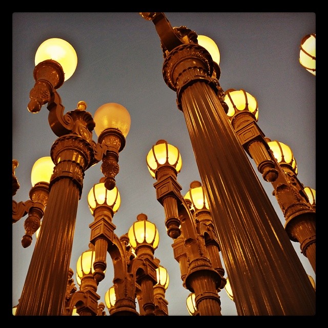 A similar view of the same lampposts, but it's cropped square and everything is faded, making it look like an old photograph.