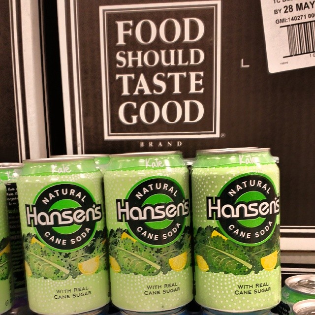 Six-pack of Hansen's kale-flavored natural cane sugar soda, in front of a sign that says Food should taste good.
