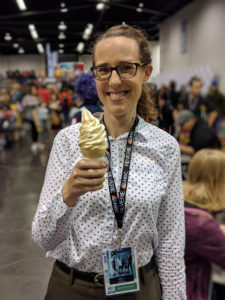 Woman in an office shirt with glasses and ice cream