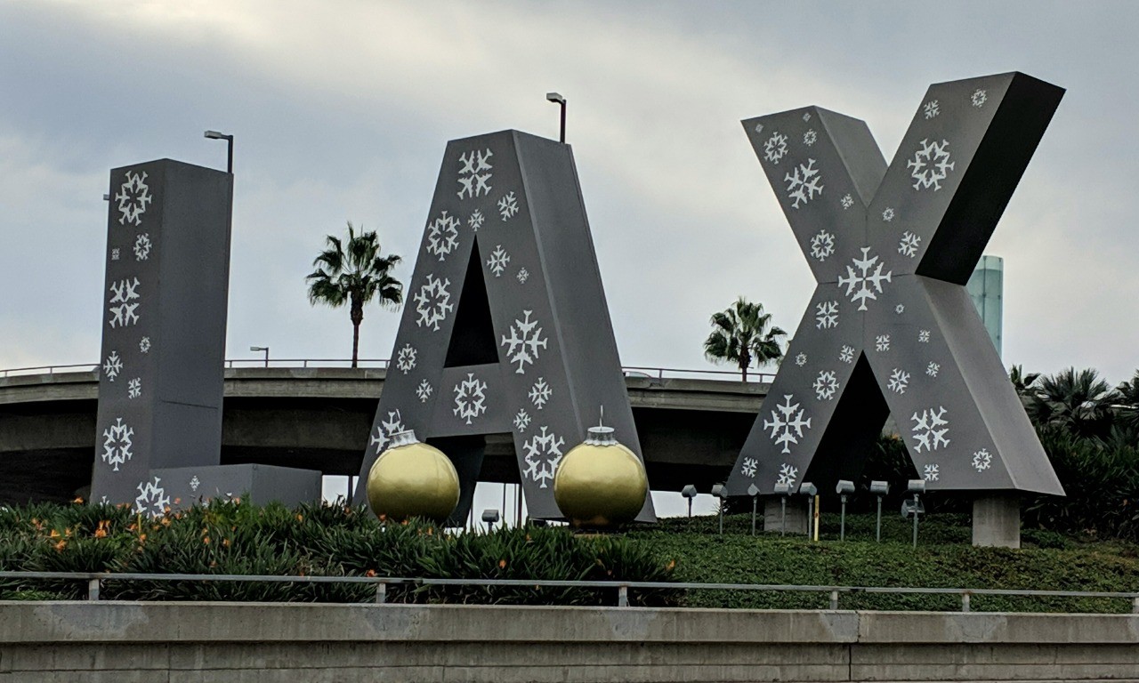 Giant standing LAX letters, with Christmas ornaments and snowflake decorations on them for winter.