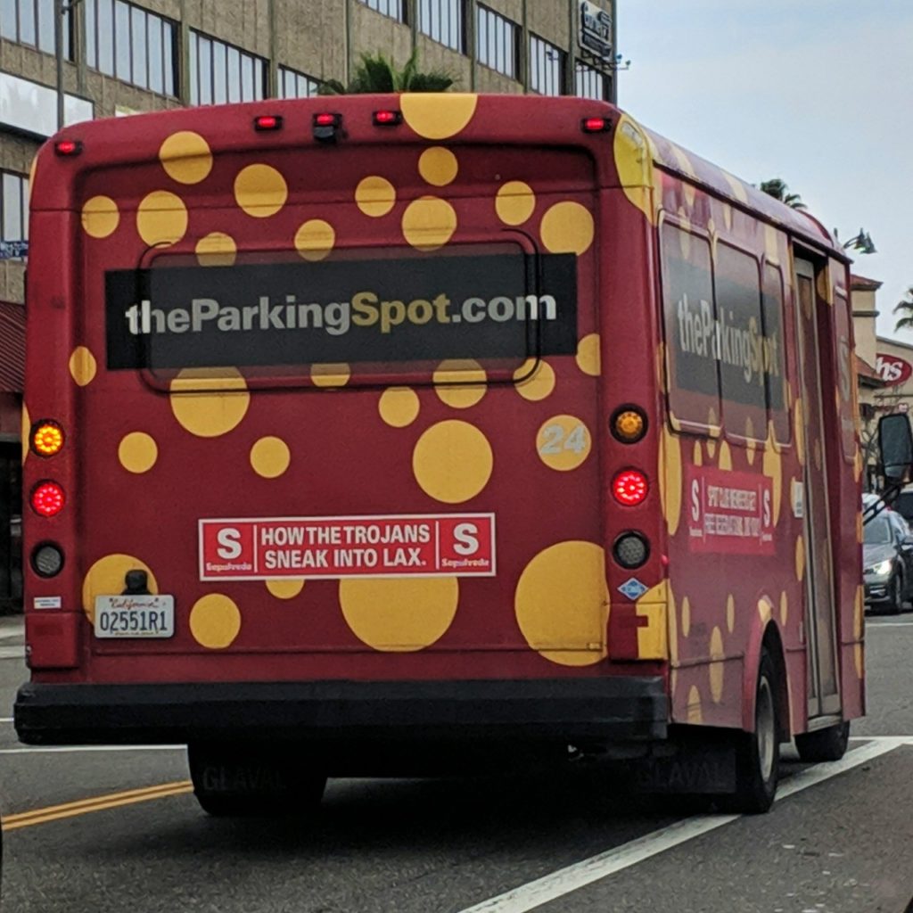 Airport shuttle with a sign: How the Trojans sneak into LAX.