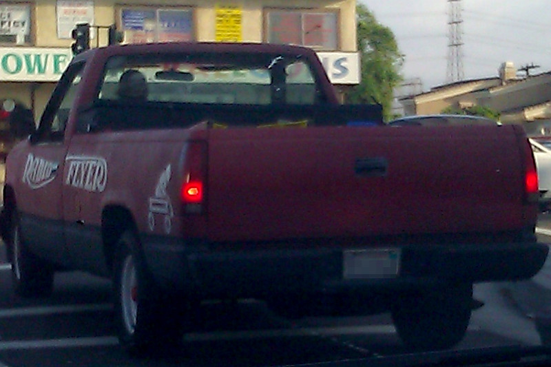 Pickup truck painted like a Radio Flyer red wagon.