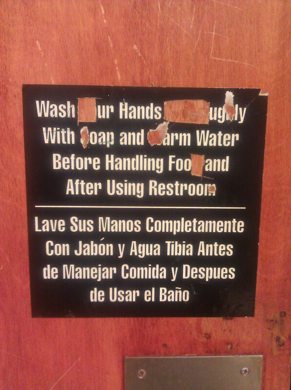 Restroom sign with letters cut out to read: Wash ur hands ugly with oap and arm water before handling foo and after using restrooi.