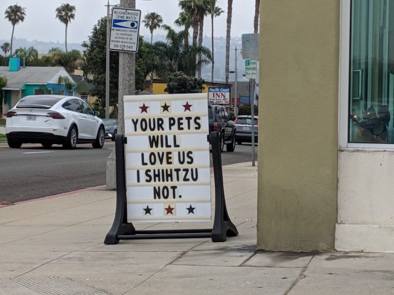 Sign: Your pets will love us. I shihtzu not.