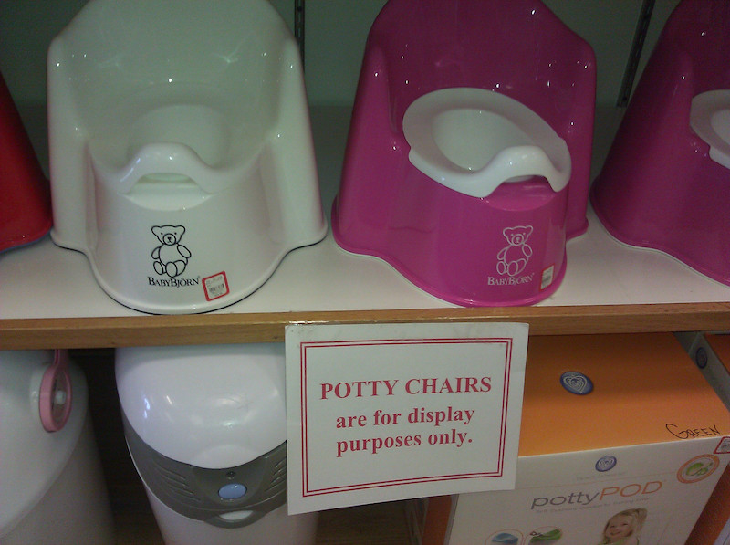 Shelves of toddlers' potties with a sign: POTTY CHAIRS are for display purposes only.