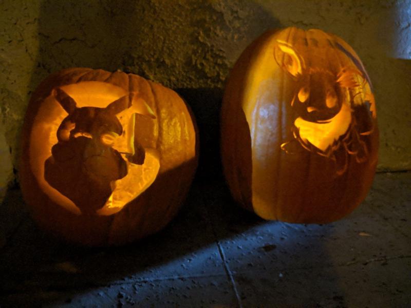 Jack-o-Lanterns carved with silhouettes of Pikachu and Eevee.