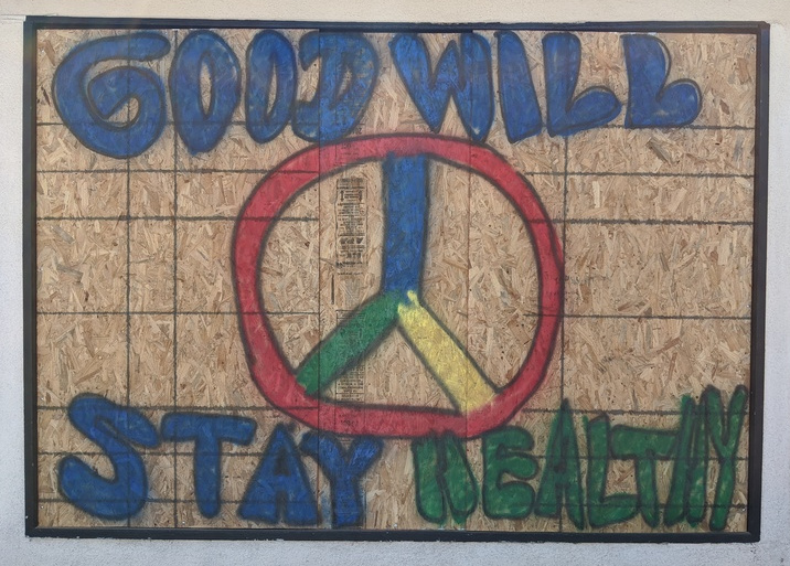 Just the plywood with GOODWILL, an incomplete Peace sign, and STAY HEALTHY.