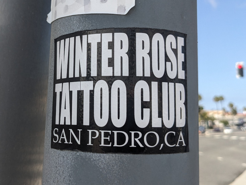Sticker on a metal post: WINTER ROSE TATTOO CLUB, San Pedro, CA