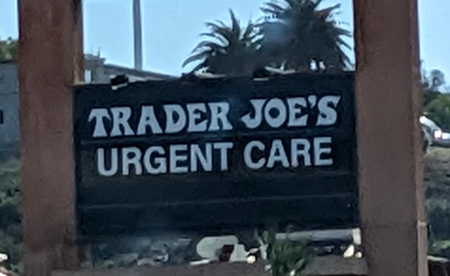 Signs at a shopping center: Trader Joe's Urgent Care