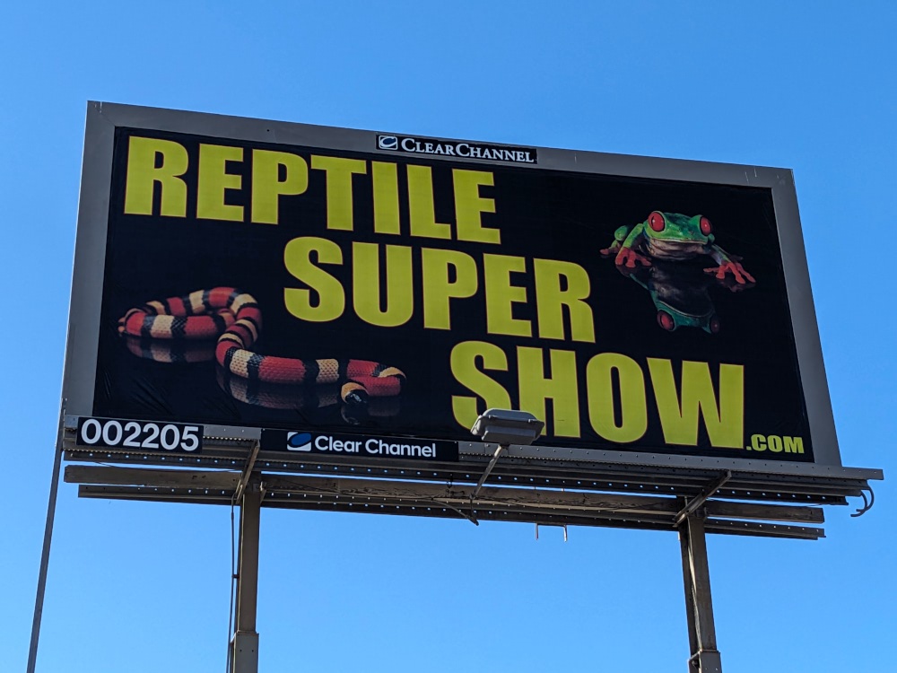 Billboard advertising REPTILE SUPER SHOW with pictures of a snake and...a frog.