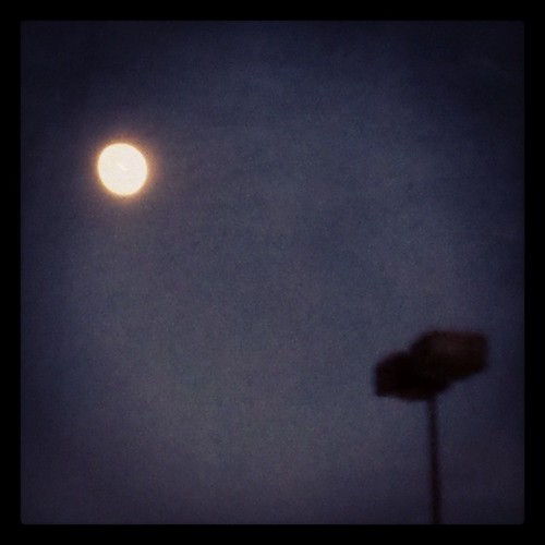 Moon and darkened streetlight