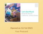 A 'postcard' featuring a wooden bench in front of a wall painted with colorful and fanciful faces, a bicycle, a dolphin and more. The card is labeled 'Let's Eat Mural' and 'Redondo Beach, California, United States.' Below the card is a note that it was opened on 12/16/2021.